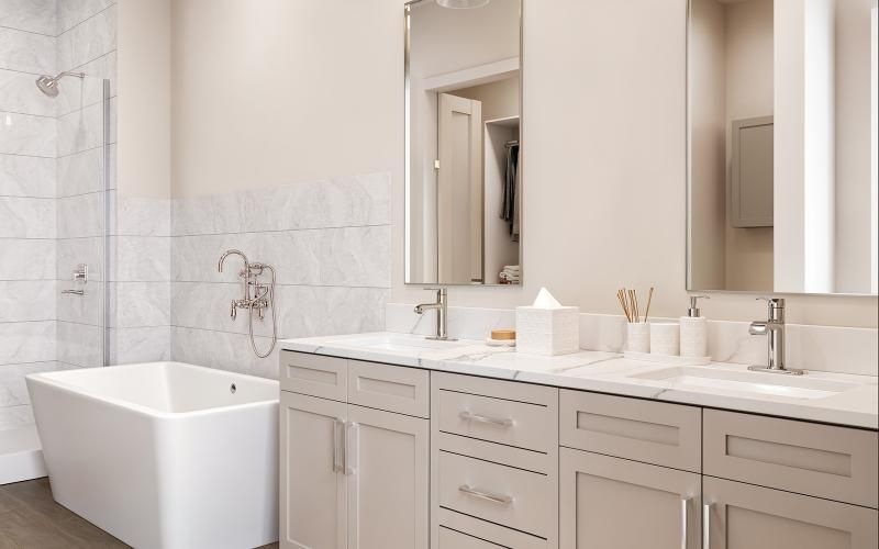 a bathroom with a tub sink and a mirror